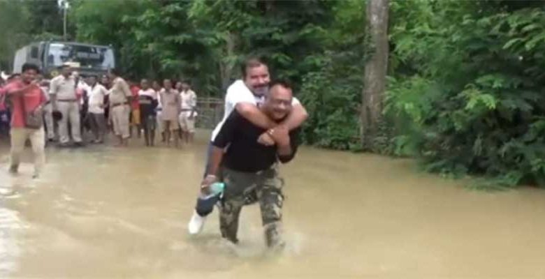Assam Flood Viral Video: BJP MLA takes piggyback ride on rescue worker's back to reach boat